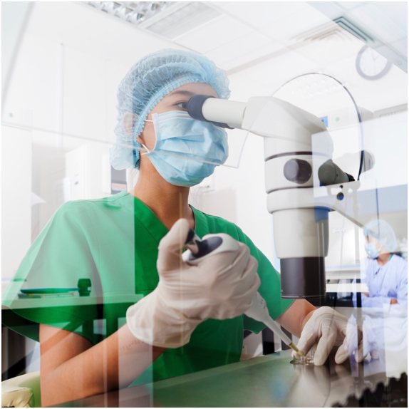 Scientist placing a sample under a microscope