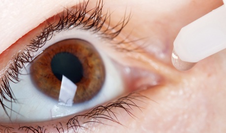 Brown eye with eye dropper