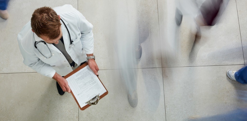 Overhead view of a doctor looking at his clipboard