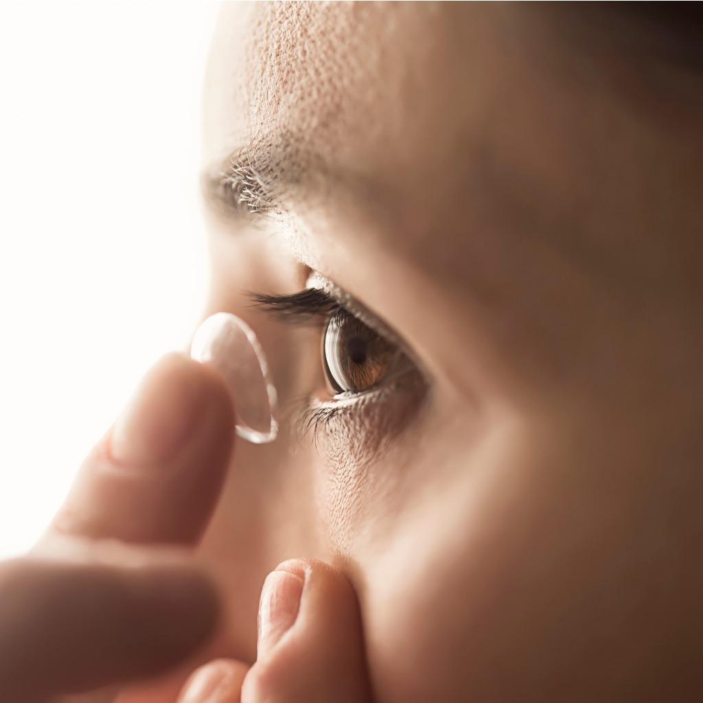 Woman putting in a contact lens